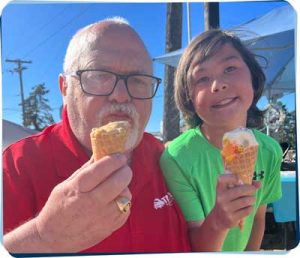 John advanced his career by founding TransCold, he shares an ice cream cone with his grandson here.